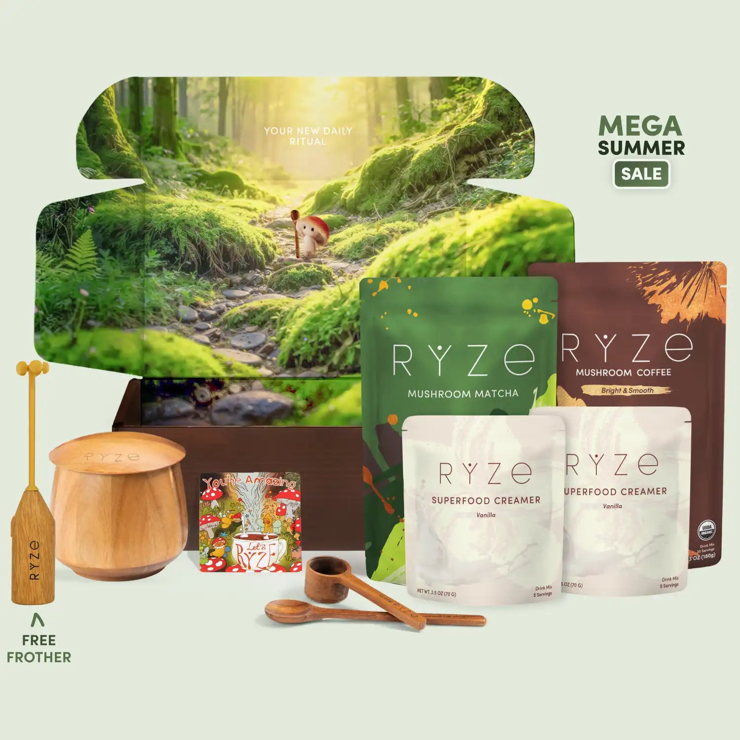 RYZE gift set featuring mushroom matcha and mushroom coffee in pouches, a wooden bowl and spoon set, a wooden spoon with a straw, and a large forest-themed gift box on a pale green background with 'MEGA SUMMER SALE' text.