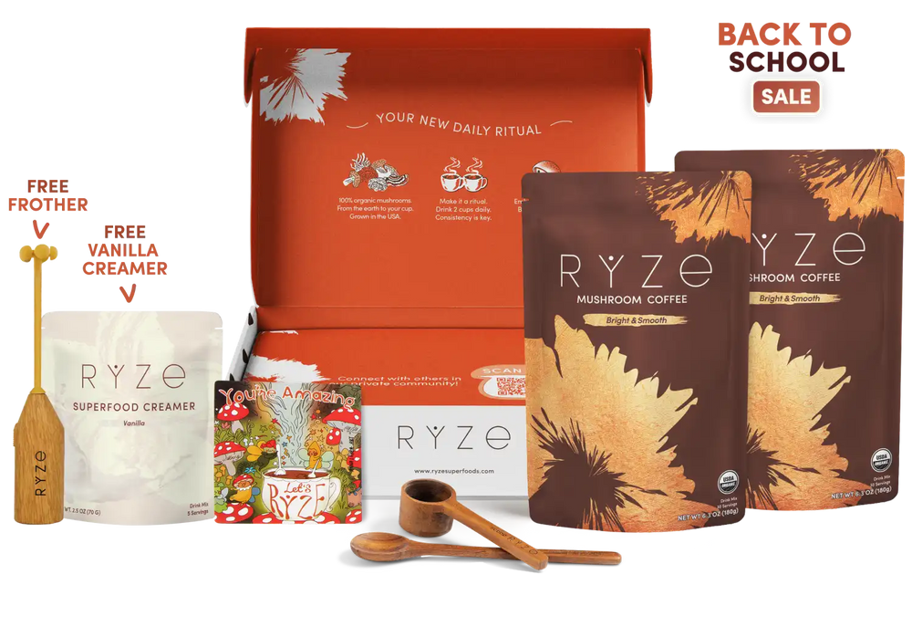 RYZE coffee gift set with an open orange box, two stand-up pouches of mushroom and bloom coffee, a vanilla creamer pouch, a wooden frother, measuring cups, and a 'Back to School Sale' promotional badge on a white background.