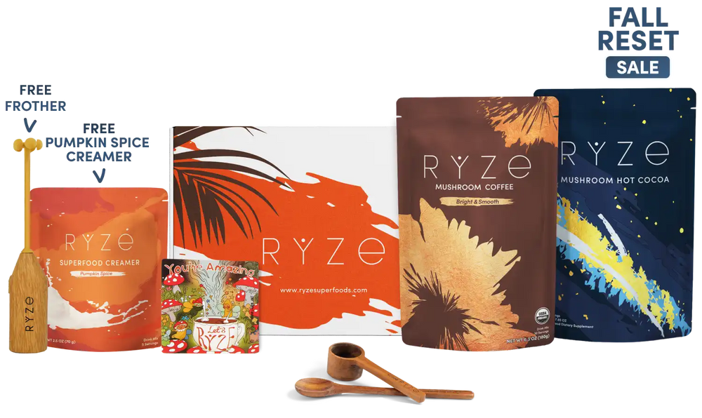 A Ryze fall reset sale bundle featuring multiple product pouches including Mushroom Coffee, Mushroom Hot Cocoa, and Creamer, along with two wooden measuring spoons and a wooden frother. The image includes promotional text overlays for 'Free Frother' and 'Free Pumpkin Spice Creamer' and a 'Fall Reset Sale' badge.