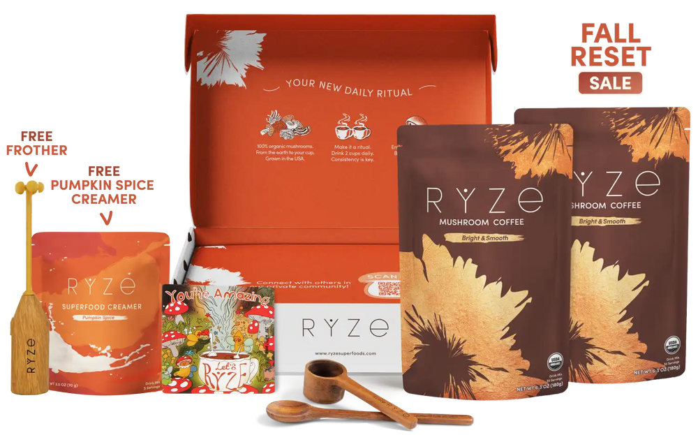 A RYZE fall harvest gift set displayed against a white background, featuring an open orange gift box, two brown mushroom coffee pouches with gold leaf graphics, a pouch of buffered creamer, a small illustrated magnet, a wooden spoon, a scoop, and a free pumpkin spice creamer with a wooden frother. Text on the image reads 'FALL RESET SALE'.